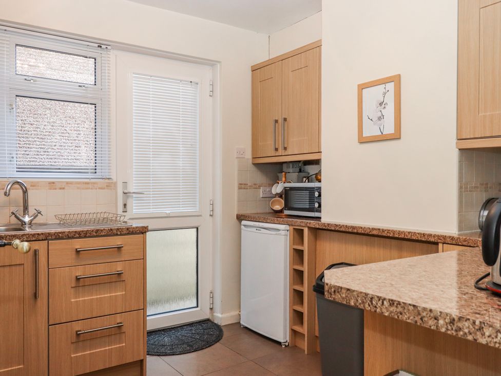 A kitchen with a sink and microwave at 7 Erme Drive Ivybridge