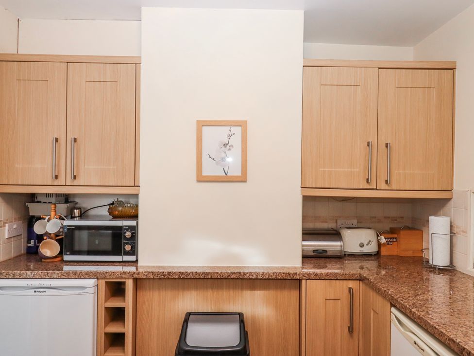A kitchen with cabinets, microwave, refrigerator, and countertop surfaces at 7 Erme Drive, Ivybridge