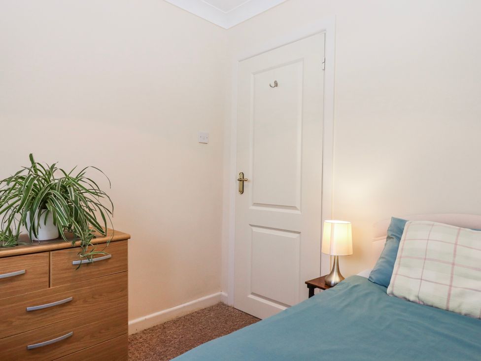 A bedroom with a bed and plant at 7 Erme Drive, Ivybridge