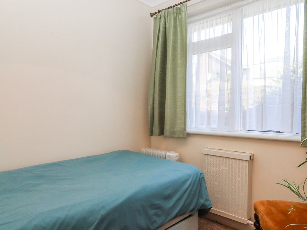 A bedroom with a bed and radiator at 7 Erme Drive in Ivybridge