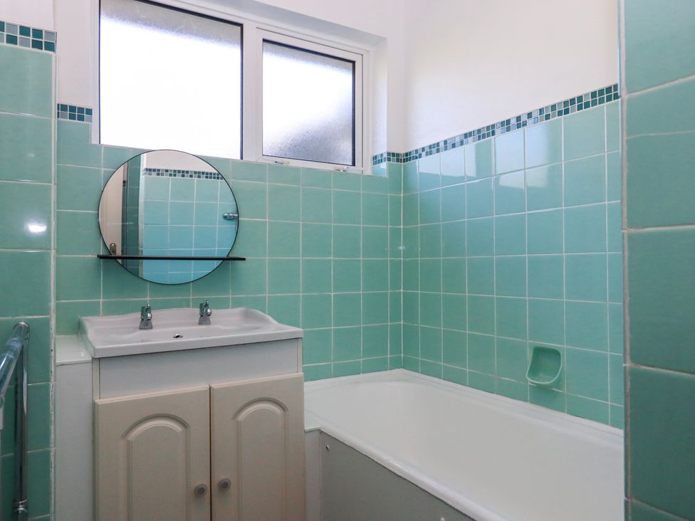 A bathroom with a sink and bathtub at 7 Erme Drive in Ivybridge