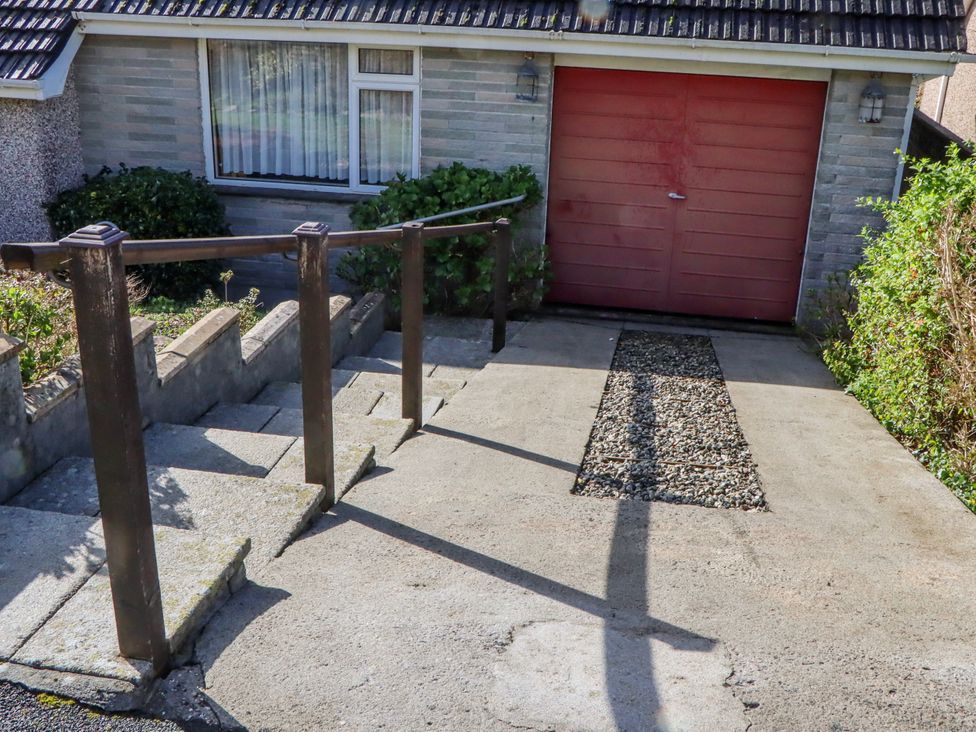 An outdoor view of a garage and stairs at 7 Erme Drive in Ivybridge