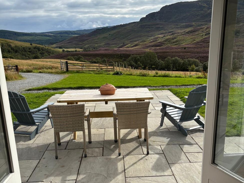 An outdoor seating area with a table and chairs at The Crannach in Kirkmichael, Perth And Kinross