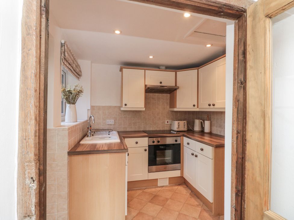 A kitchen with sink and oven at Honeysuckle Cottage in Oswaldkirk near Helmsley