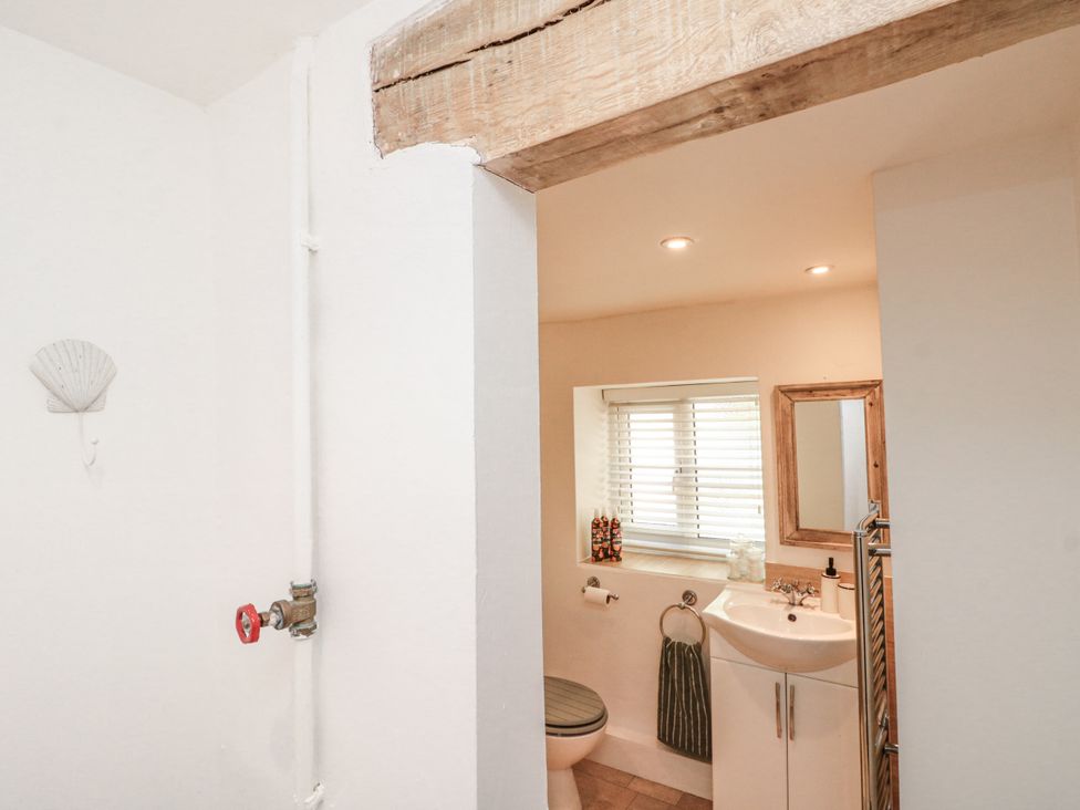 A bathroom featuring a sink and toilet at Honeysuckle Cottage in Oswaldkirk near Helmsley