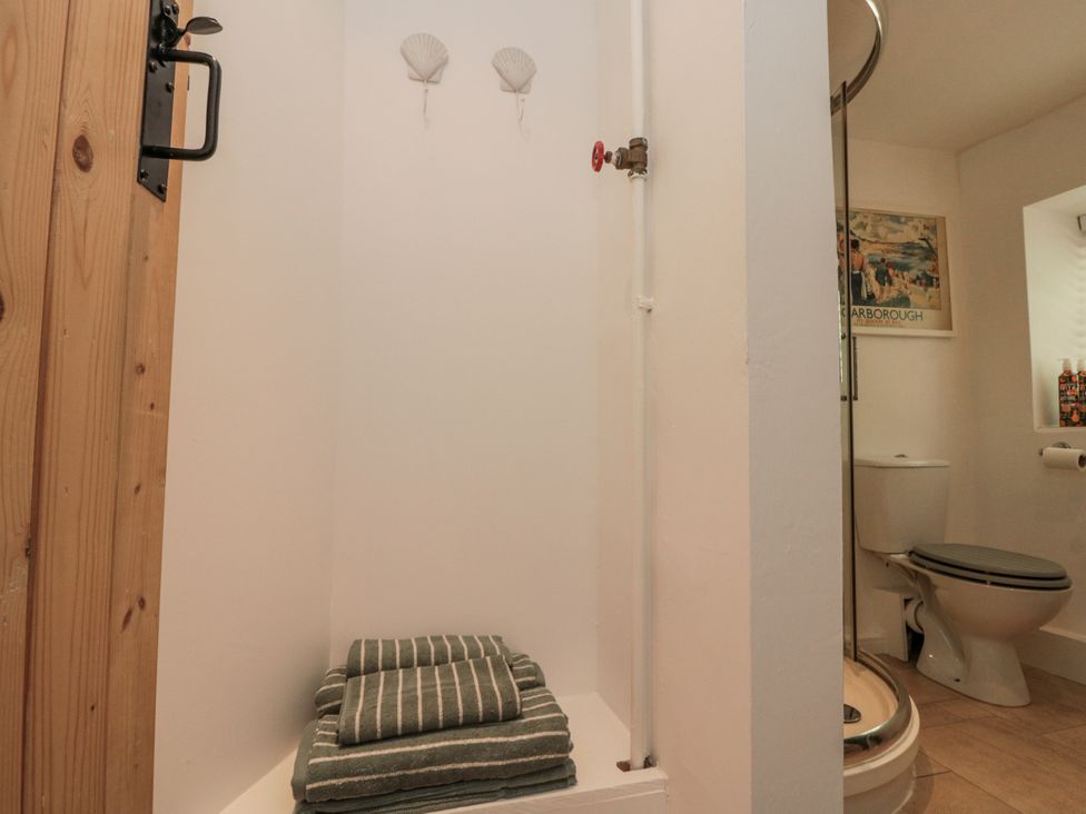 A bathroom with a shower and toilet at Honeysuckle Cottage Oswaldkirk near Helmsley
