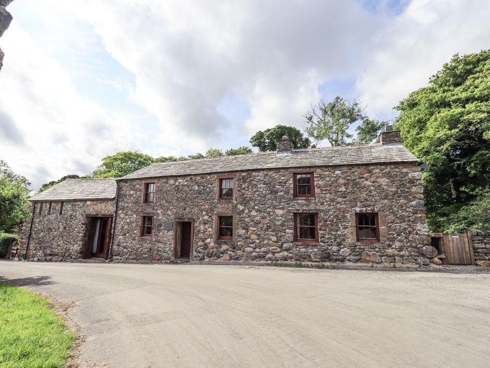 A stone building with windows and doors at Chapel Cottage in Ennerdale near Cleator Moor
