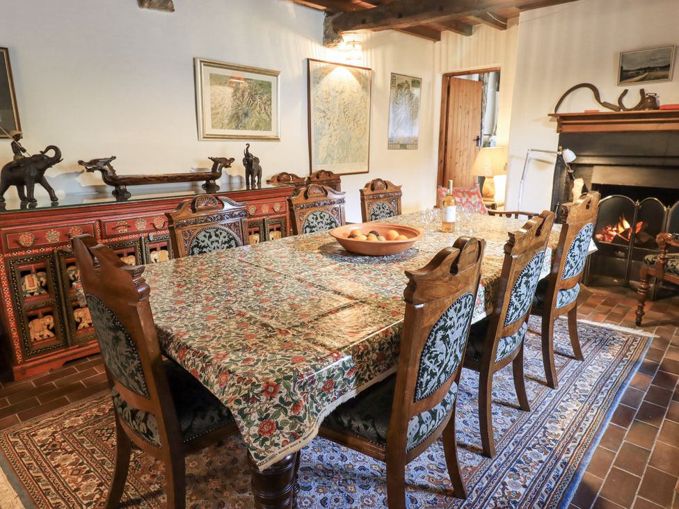 A dining room with a wooden table and chairs at Chapel Cottage Ennerdale near Cleator Moor