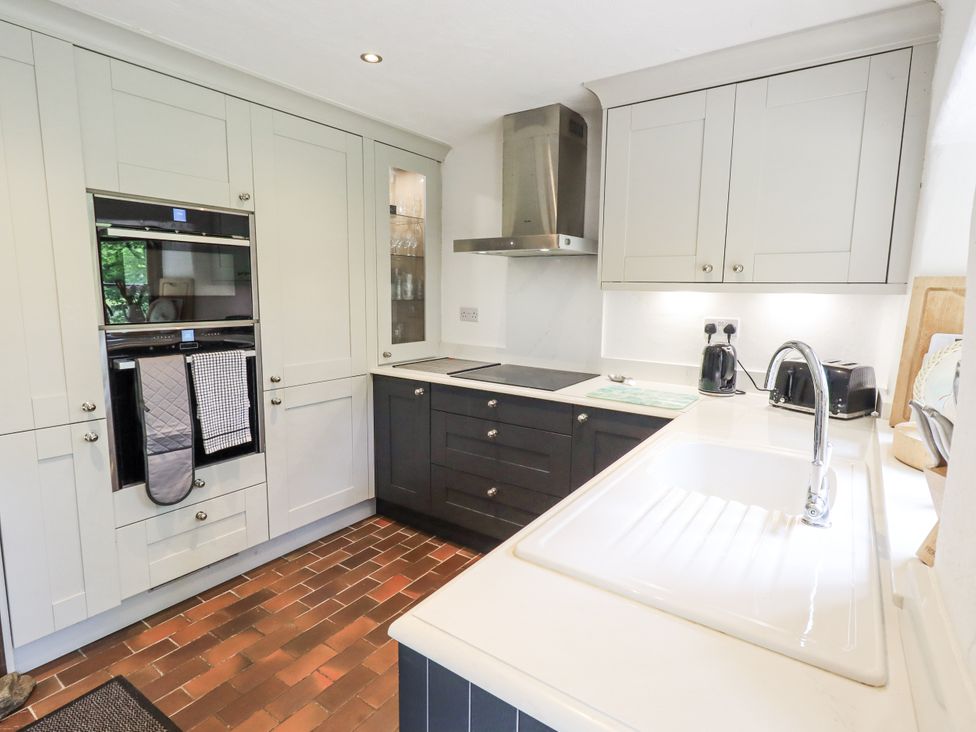 A kitchen with cabinets and appliances at Chapel Cottage in Ennerdale near Cleator Moor