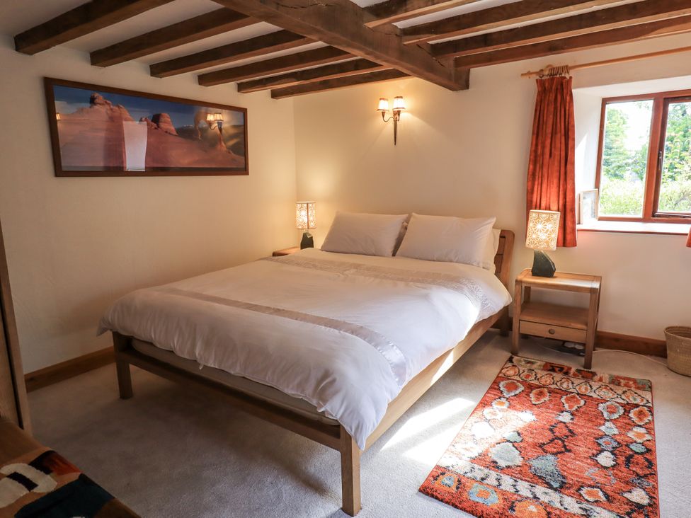 A bedroom with a bed and nightstands at Chapel Cottage Ennerdale near Cleator Moor