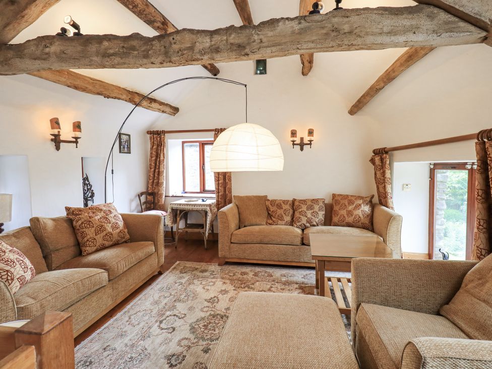 A living room with a sofa and table at Chapel Cottage in Ennerdale near Cleator Moor