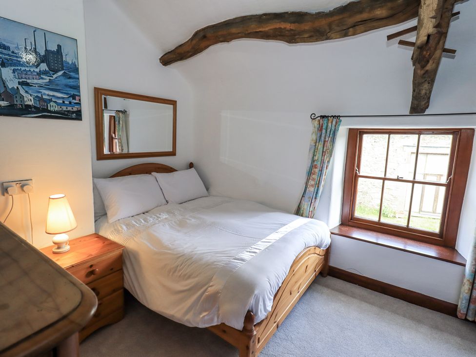 A bedroom with a bed and a window at Chapel Cottage in Ennerdale near Cleator Moor