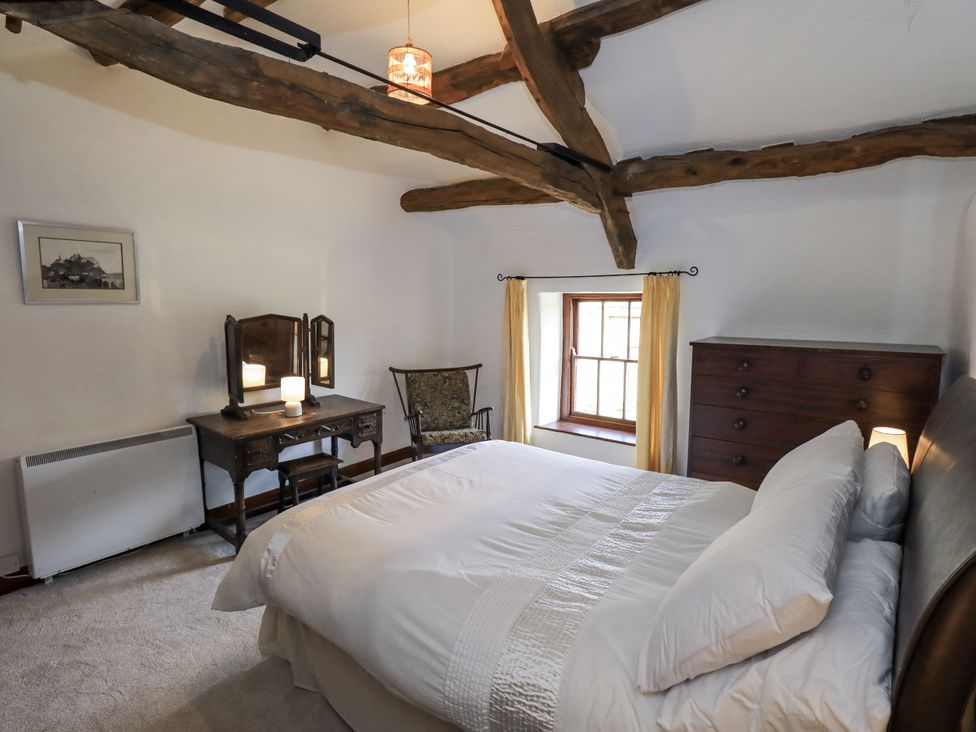 A bedroom with a bed and furniture at Chapel Cottage in Ennerdale near Cleator Moor