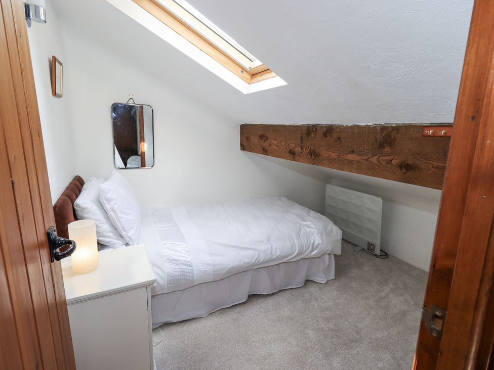 A bedroom with a bed and nightstand at Chapel Cottage Ennerdale near Cleator Moor