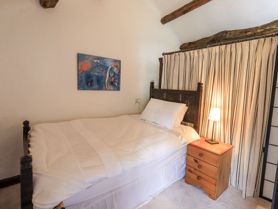 A bedroom with a bed and bedside table at Chapel Cottage in Ennerdale near Cleator Moor