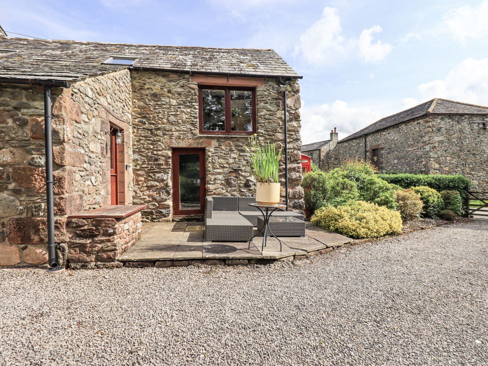 An outdoor seating area near a stone building at Chapel Cottage in Ennerdale near Cleator Moor