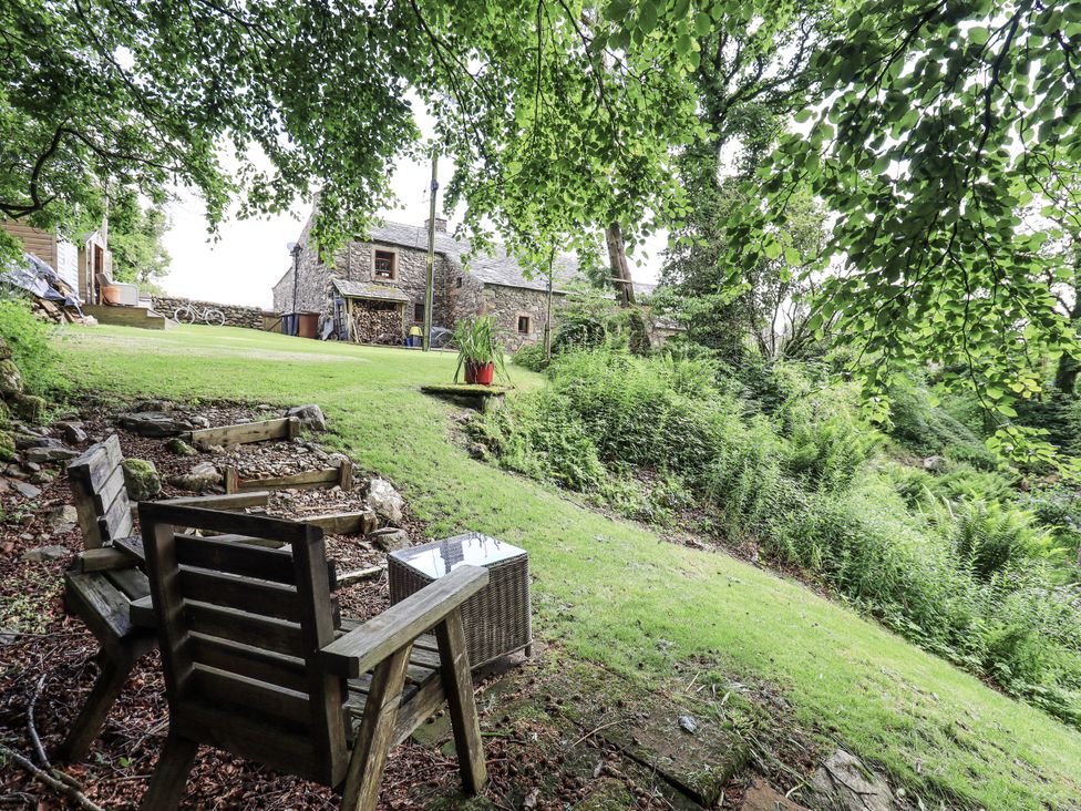 A garden with chairs and a table at Chapel Cottage in Ennerdale near Cleator Moor