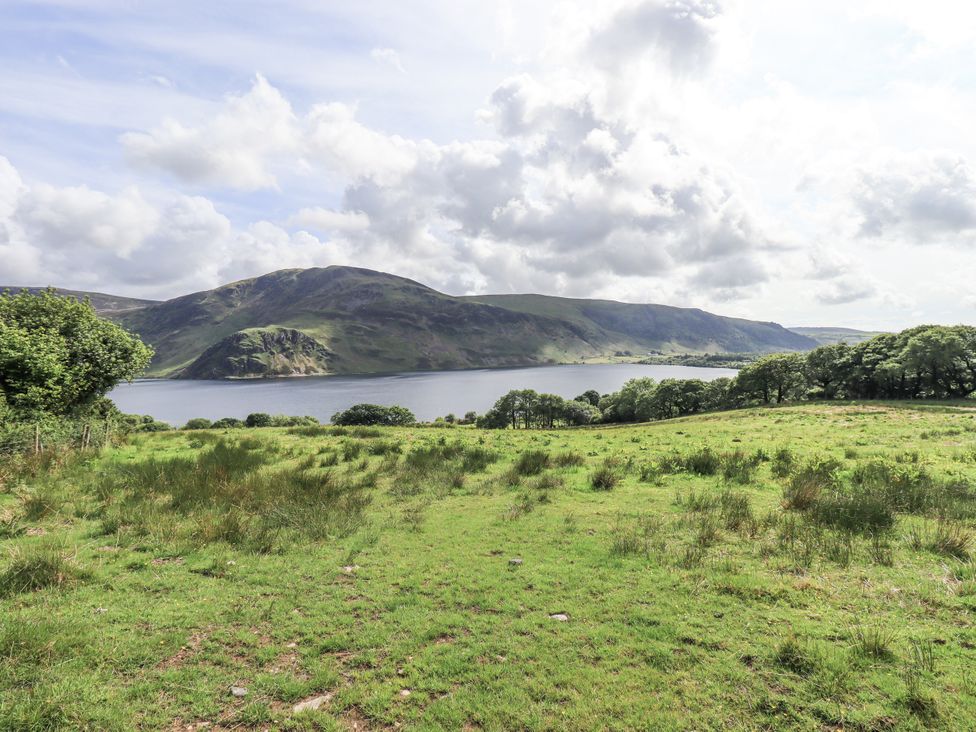 A view of a lake surrounded by mountains at Chapel Cottage in Ennerdale near Cleator Moor