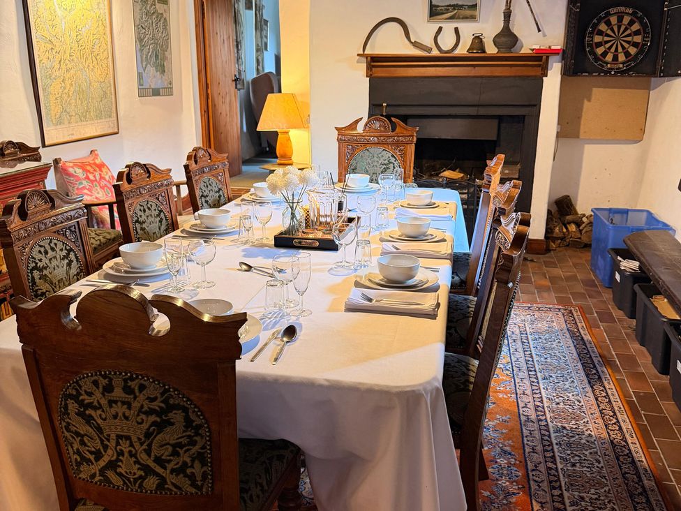 A dining room with a set dining table and a dartboard at Chapel Cottage Ennerdale