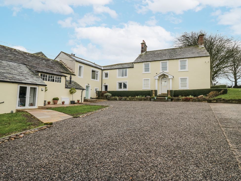 A house with a driveway and garden at Swift Barn in Wigton