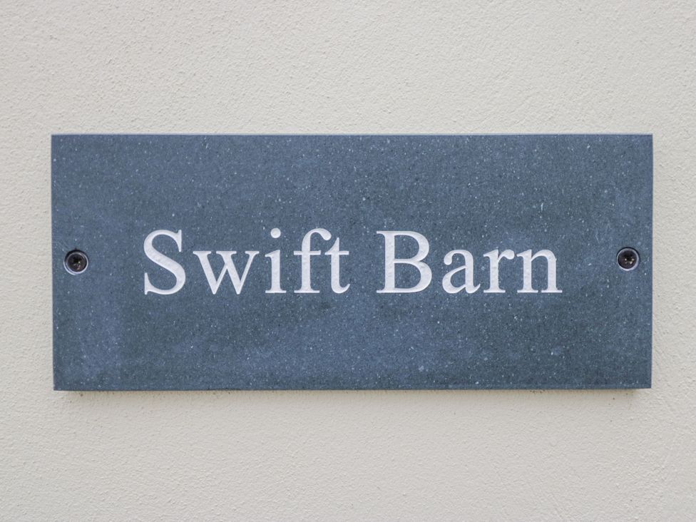 A nameplate with the text Swift Barn at Swift Barn in Wigton