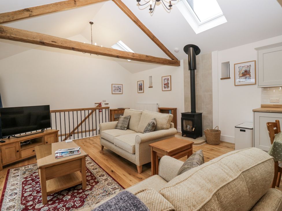 A living room with a sofa and television at Swift Barn in Wigton