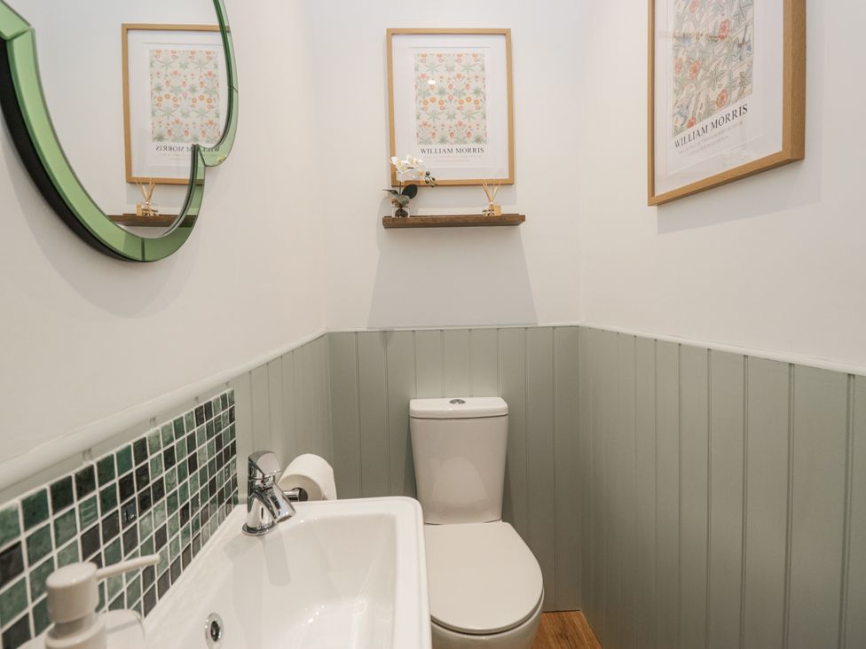A bathroom with a toilet and a sink at Swift Barn in Wigton