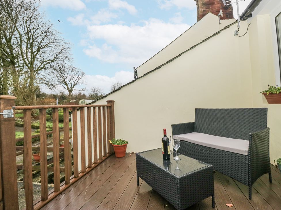 An outdoor area with a sofa and table at Swift Barn, Wigton