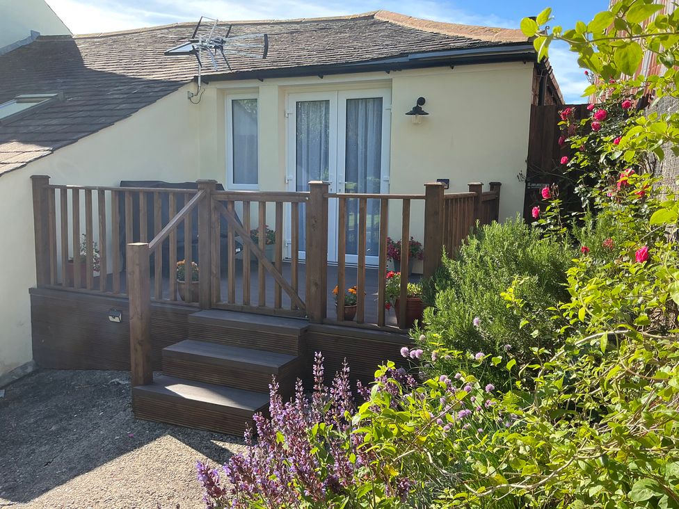 An outdoor area with a deck and steps at Swift Barn in Gilcrux