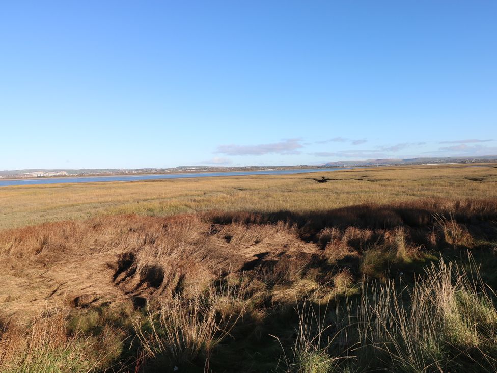 A landscape with water and grass at Kites - 52 Gower Holiday Village Scurlage near Port Eynon and Rhossili