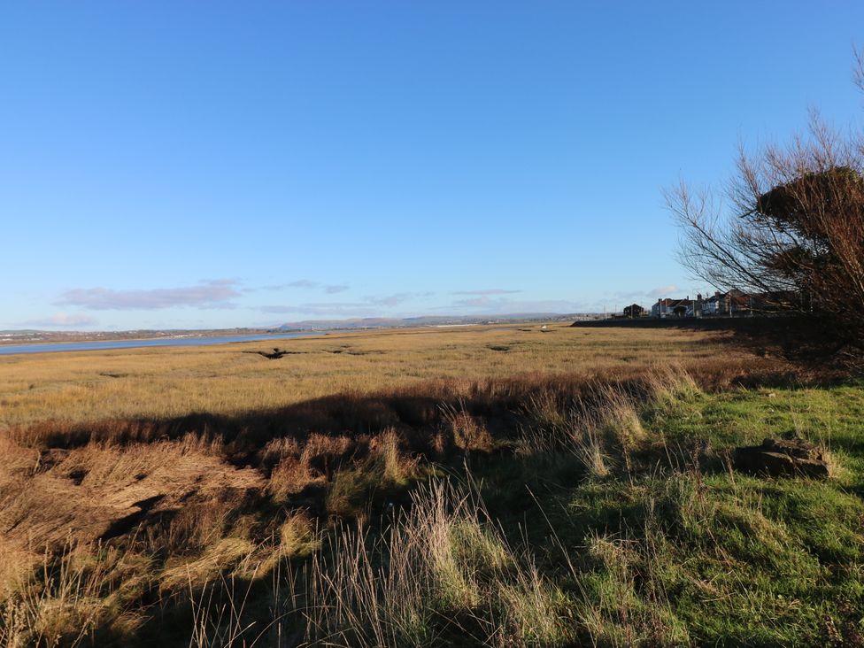 A landscape with grass and water at Kites - 52 Gower Holiday Village Scurlage near Port Eynon and Rhossili
