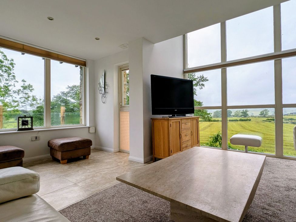 A living room with a tv and coffee table at High View Meadows in Kirkby Lonsdale