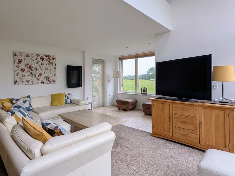 A living room with a television and a coffee table at High View Meadows in Kirkby Lonsdale