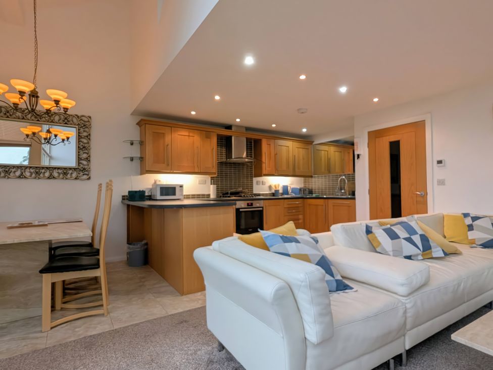 A living room with kitchen elements and furniture at High View Meadows in Kirkby Lonsdale