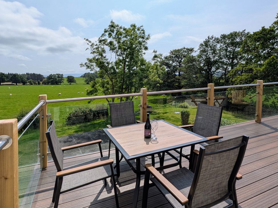 An outdoor seating area with a table and chairs at High View Meadows in Kirkby Lonsdale