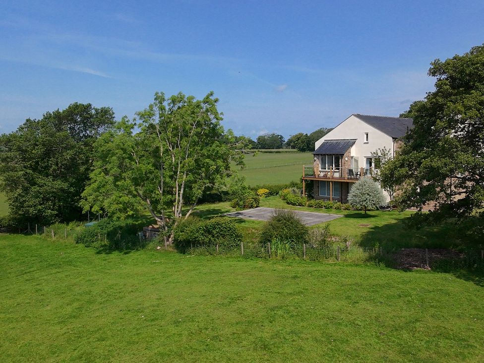 A house with a balcony and garden at High View Meadows in Kirkby Lonsdale