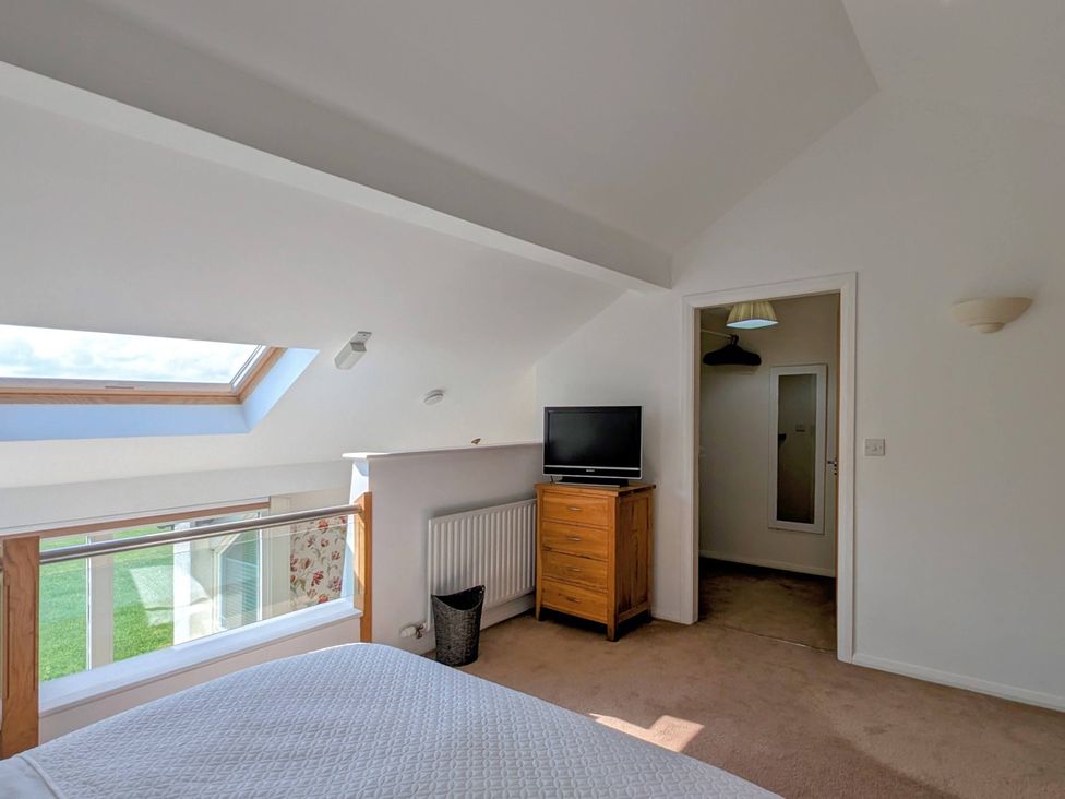 A bedroom with a television and a dresser at High View Meadows in Kirkby Lonsdale