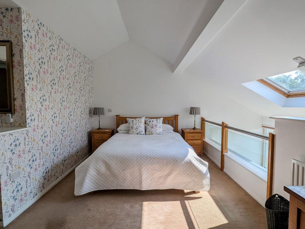 A bedroom with a bed and nightstands at High View Meadows in Kirkby Lonsdale