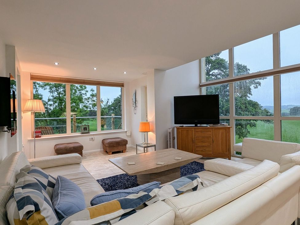 A living room with a sofa and television at High View Meadows in Kirkby Lonsdale