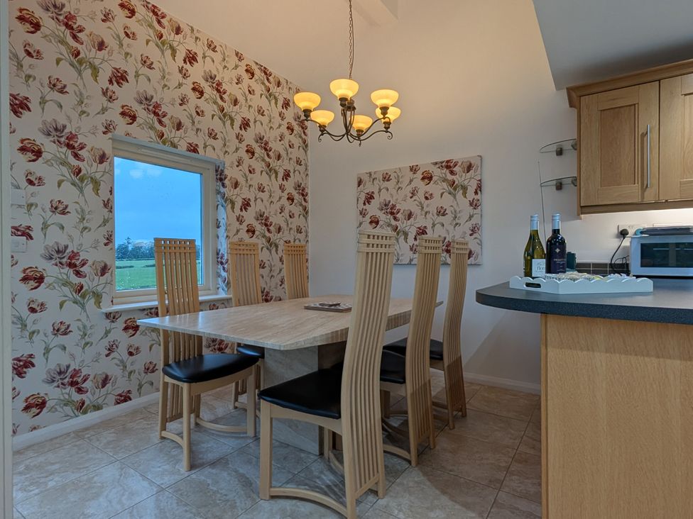 A dining room with a table and chairs at High View Meadows in Kirkby Lonsdale