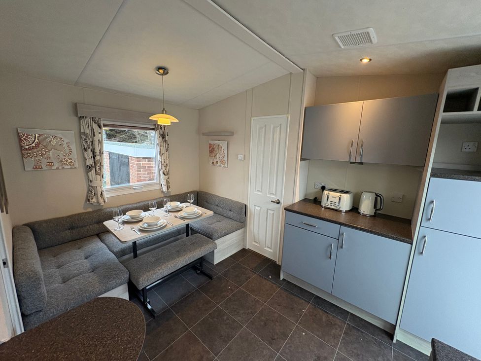 A kitchen with a dining area and appliances at Caravan 941 Clacton-On-Sea