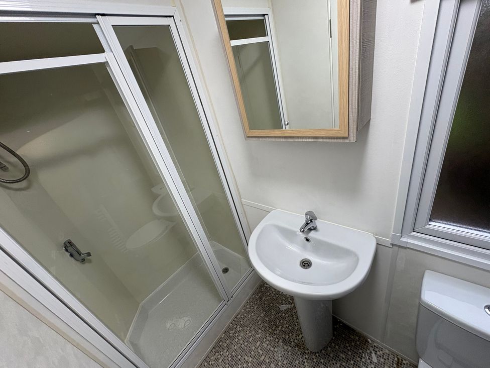 A bathroom with a shower, sink, and toilet at Caravan 941, Clacton-On-Sea