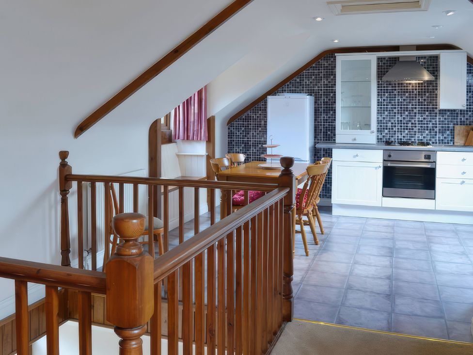 A kitchen with a table and chairs at The Coach House Budock Water near Falmouth