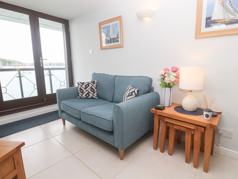 A living room with a sofa and side table at Tobys Quay in Falmouth