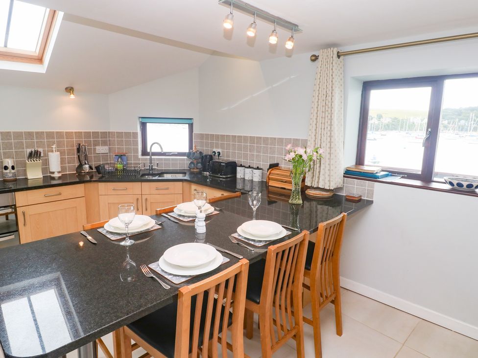 A kitchen with a counter and seating at Tobys Quay in Falmouth