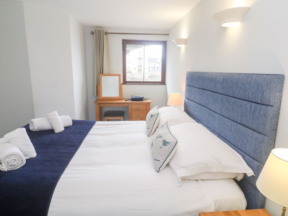 A bedroom with a double bed and desk at Tobys Quay, Falmouth