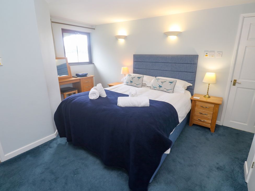 A bedroom with a bed and a desk at Tobys Quay in Falmouth
