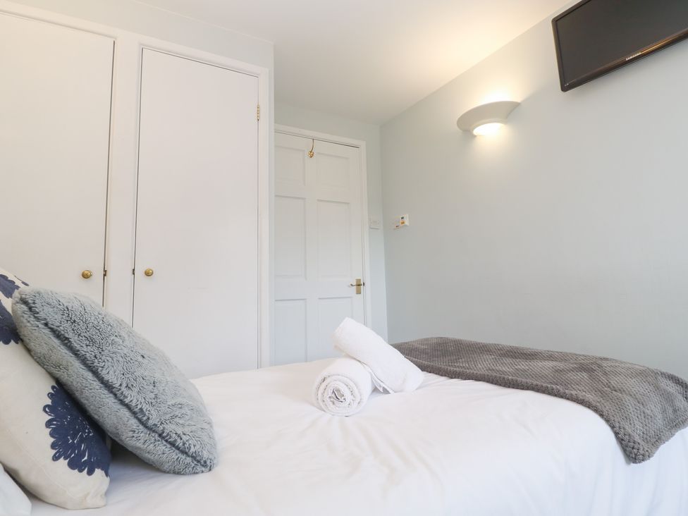 A bedroom with a bed and closet at Tobys Quay in Falmouth