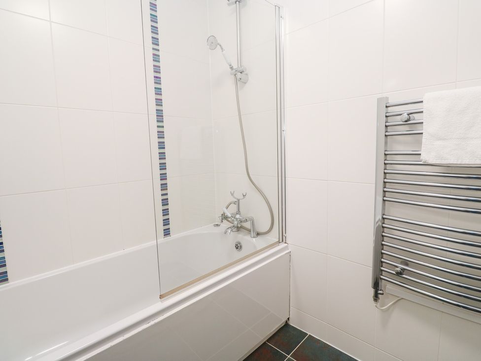 A bathroom with a bathtub and shower at Tobys Quay in Falmouth
