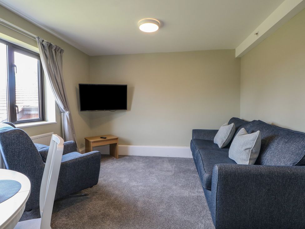 A living room with a sofa and television at Flat 1 in Littlehampton